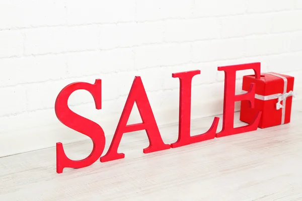 Sale with gift on floor in room — Stock Photo, Image