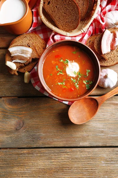 Ukrainian beetroot soup - borscht, on napkin, on wooden background — Stock Photo, Image