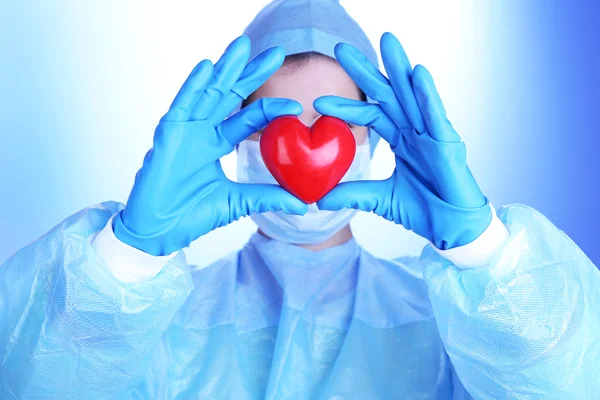 Doctor holding decorative heart — Stock Photo, Image