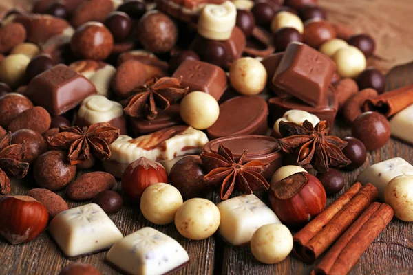 Different kinds of chocolates on wooden table close-up — Stock Photo, Image
