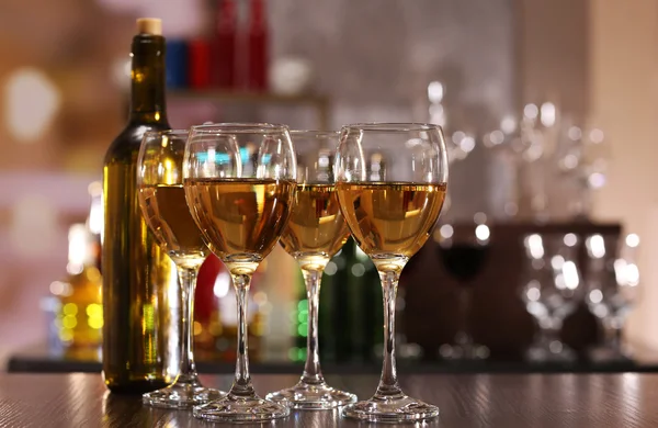 Glasses of wine on counter and bar on background — Stock Photo, Image