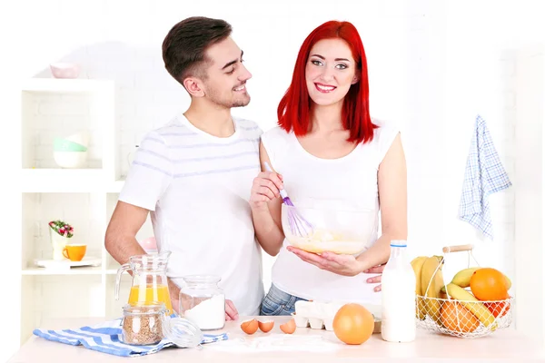 Happy couple preparing dough baking in kitchen — Stock Photo, Image
