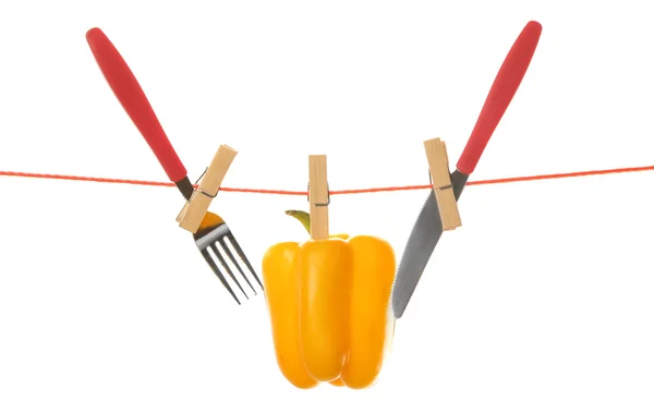 Fork, knife and bell pepper hanging from clothesline isolated on white background — Stock Photo, Image