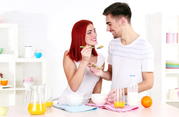Happy couple has breakfast in kitchen — Stock Photo, Image