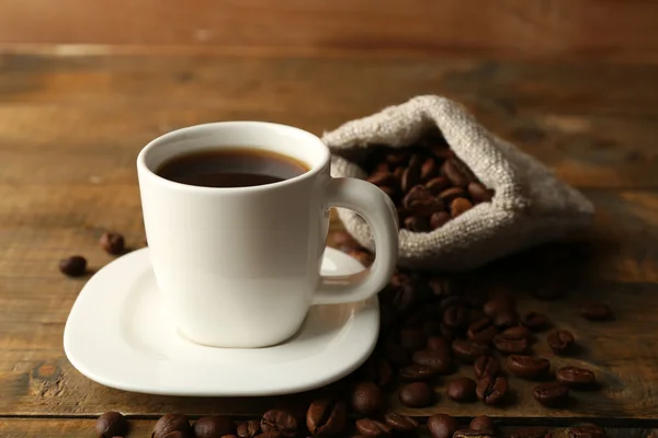 Cup of coffee with beans — Stock Photo, Image