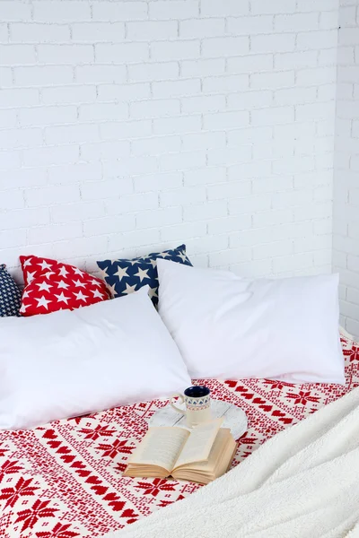 Book and cup of tea on bed close-up — Stock Photo, Image