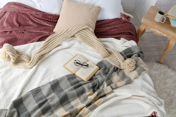 Book and glasses on bed close-up — Stock Photo, Image