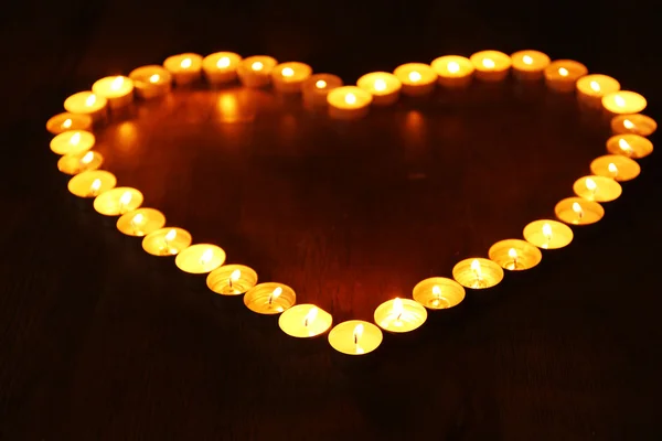 Burning candles in shape of heart on dark background — Stock Photo, Image