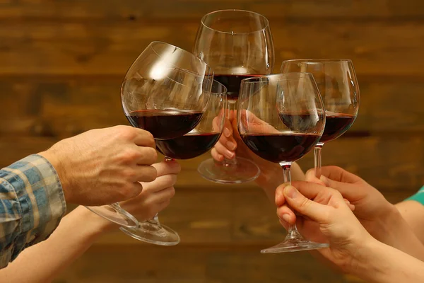Clinking glasses of red wine — Stock Photo, Image