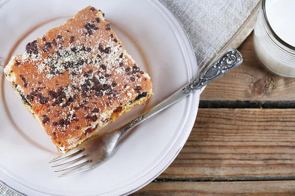 Zelfgemaakte taart met jam en een glas melk op servet en houten planken achtergrond — Stockfoto