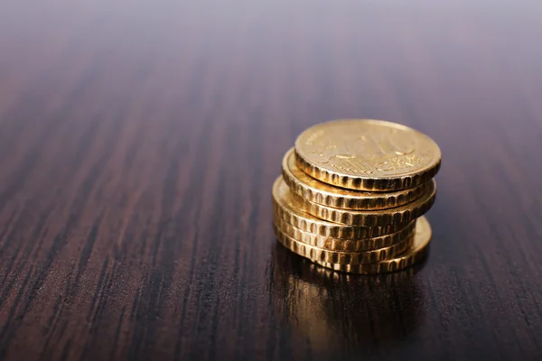 Stack av gyllene mynt på träbord bakgrund — Stockfoto