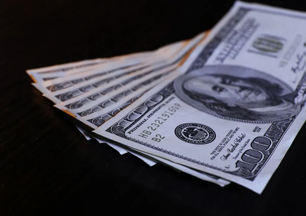 Yüz dolarlık banknotlar ahşap masa arka plan üzerinde — Stok fotoğraf
