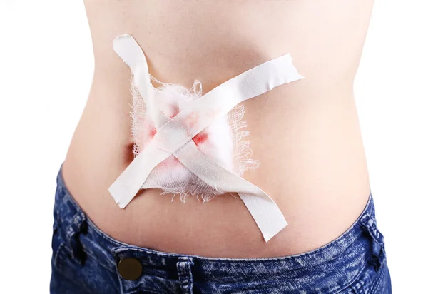 Injured abdomen with adhesive bandage — Stock Photo, Image