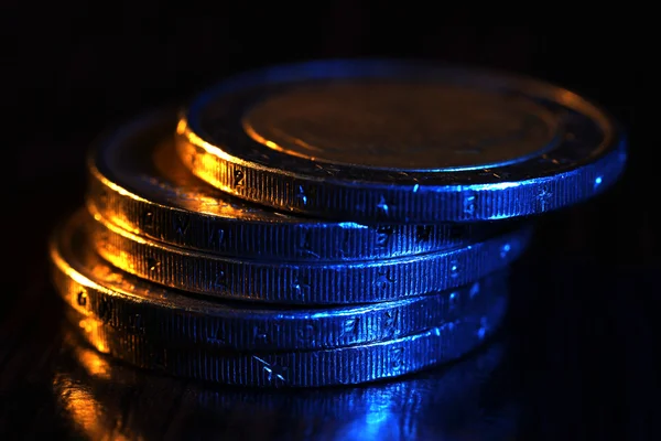 Heap of coins on wooden table — Stock Photo, Image