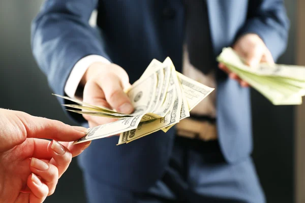 Businessman giving money — Stock Photo, Image