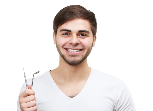 Hombre sonriente con herramientas dentales — Foto de Stock