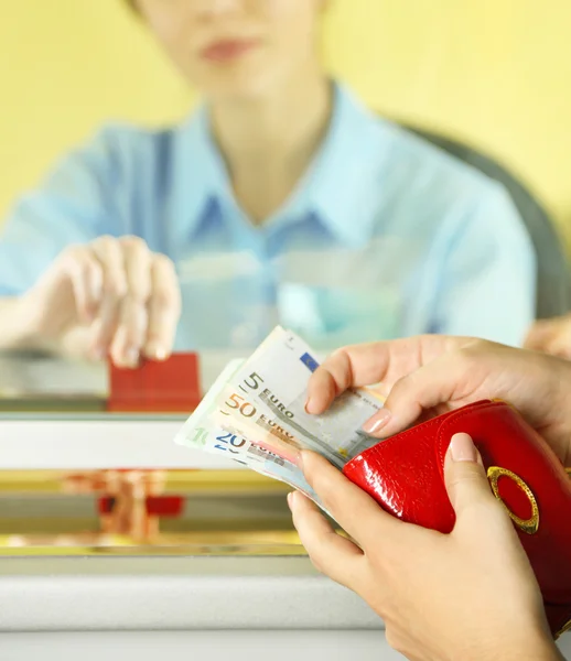Teller window with working cashier — Stock Photo, Image