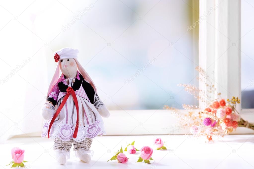 Handmade doll near window