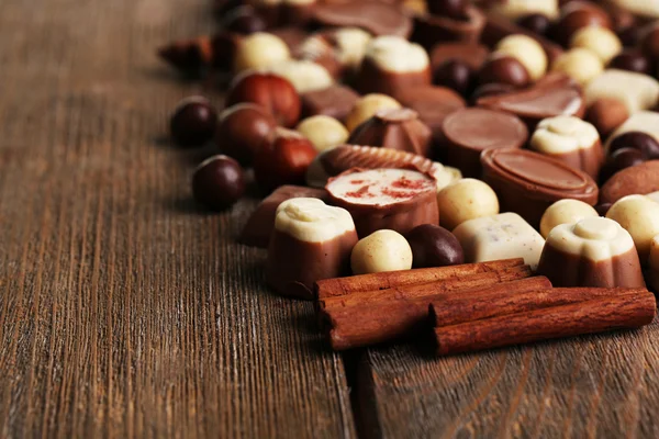 Different kinds of chocolates on wooden table close-up — Stock Photo, Image