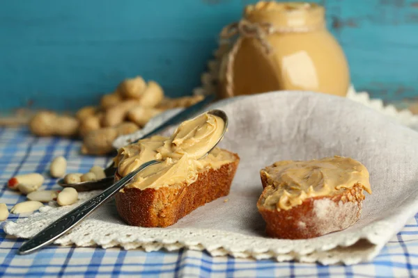 Tasty sandwiches with fresh peanut butter on wooden background — Stock Photo, Image