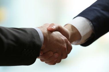 Parlak arkaplanda iş tokalaşması