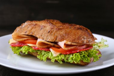 Ahşap arka plan üzerinde tabakta sebze ve peynir ile taze ve lezzetli sandviç