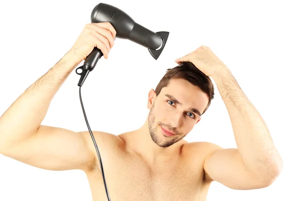Handsome young man blow drying his hair isolated on white — Stock Photo, Image