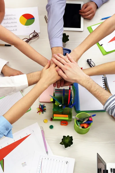 United hands of business team on workspace background top view — Stock Photo, Image