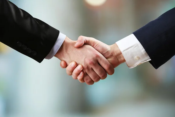 Business handshake on bright background — Stock Photo, Image