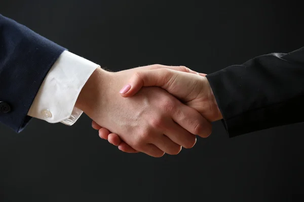 Business handshake on dark background — Stock Photo, Image