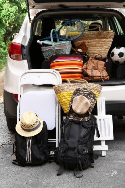 Suitcases and bags in trunk of car ready to depart for holidays clipart