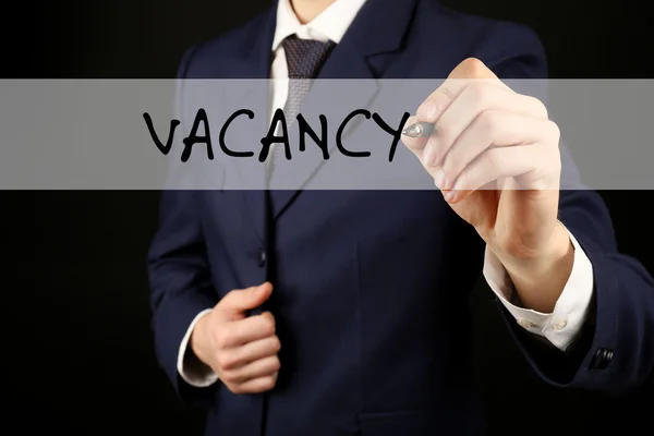 Businessman writing VACANCY at transparent whiteboard, close-up — Stock Photo, Image