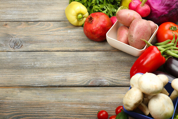 Summer frame with fresh organic vegetables and fruits on wooden background