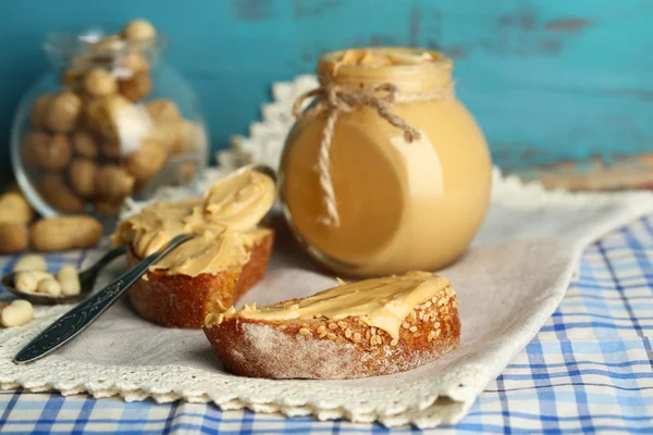 Tasty sandwiches with fresh peanut butter on wooden background — Stock Photo, Image