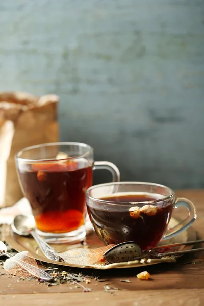 Beautiful vintage composition with herbal tea, on wooden table — Stock Photo, Image