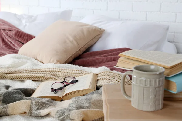Книга и очки на кровати — стоковое фото