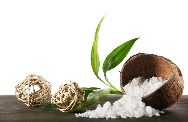 Cáscara de coco de sal marina con bolas de mimbre y pétalos verdes aislados en blanco —  Fotos de Stock