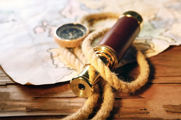 Spyglass, compass, rope and world map — Stock Photo, Image