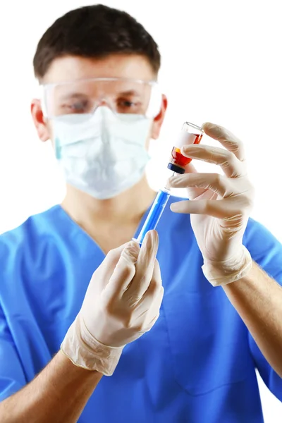 Doctor dialing medicine into syringe from glass bottle isolated on white background — Stock Photo, Image