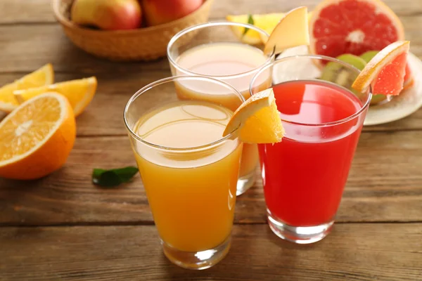 Jugos frescos con frutas en mesa de madera — Foto de Stock