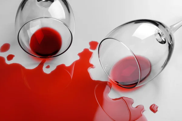 Red wine spilled from glass on white background — Stock Photo, Image