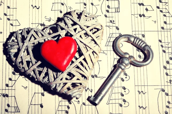 Retro key with hearts on music book background — Stock Photo, Image