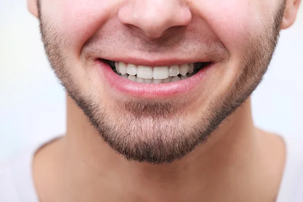 Smiling man after visit dentist isolated on white — Stock Photo, Image