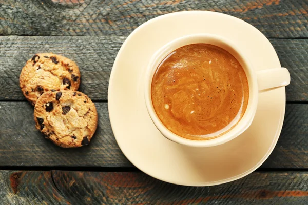 Kopp kaffe och välsmakande kakor på trä bakgrund — Stockfoto