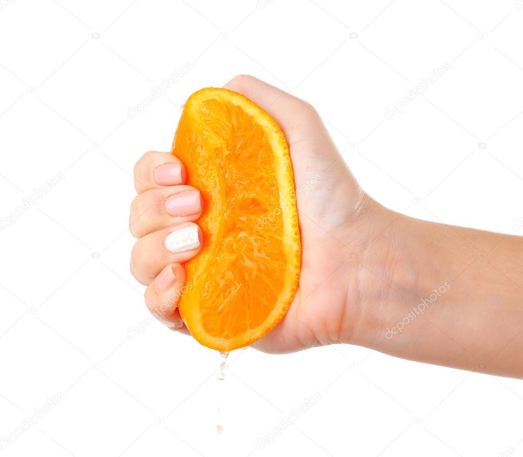 Female hand squeezing orange isolated on white