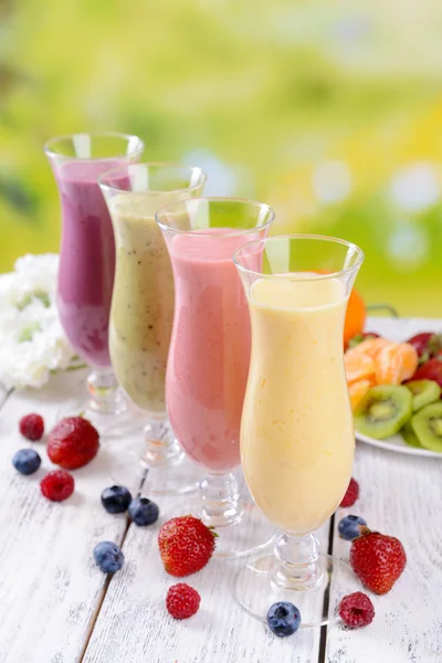 Delicious berry cocktails on table on bright background — Stock Photo, Image