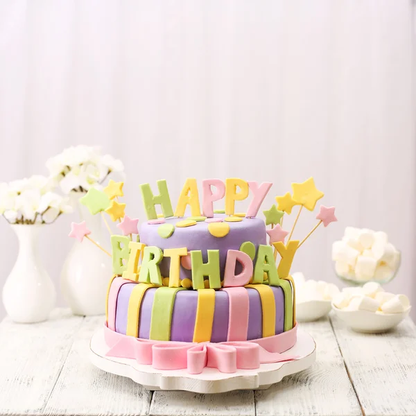 Delicious birthday cake on table on light background — Stock Photo, Image