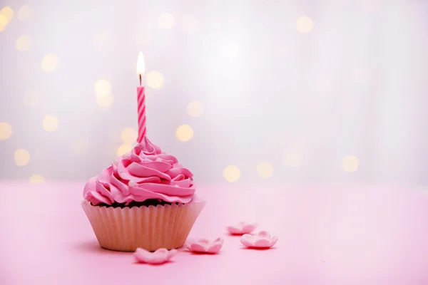 Delicious birthday cupcake on table on light background — Stock Photo, Image