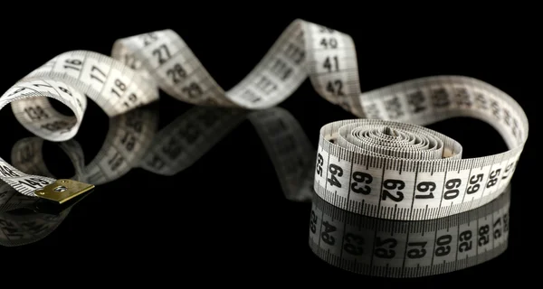 Measuring tape on black background — Stock Photo, Image