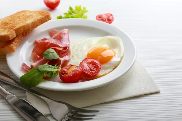 Bacon et oeufs sur fond de table en bois couleur — Photo